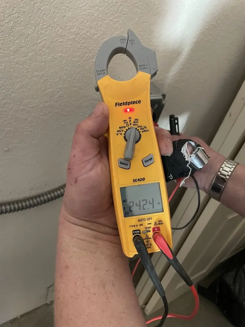 Voltage testing with clamp meter during Outlet Installation in Macon-Bibb County